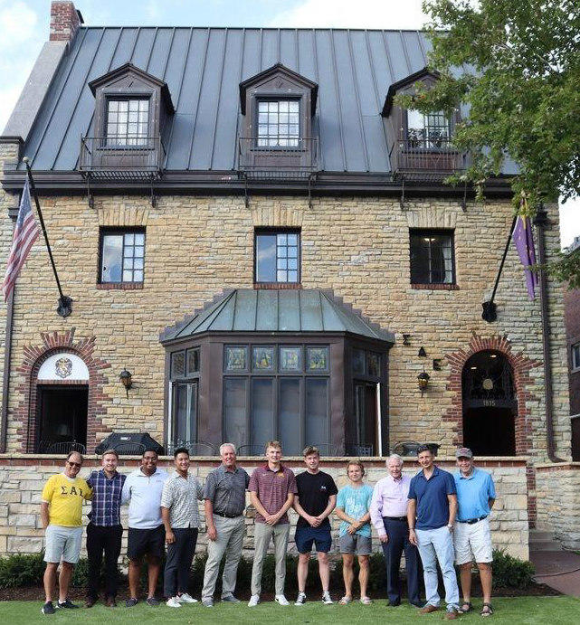 SAE group in front of fraternity house